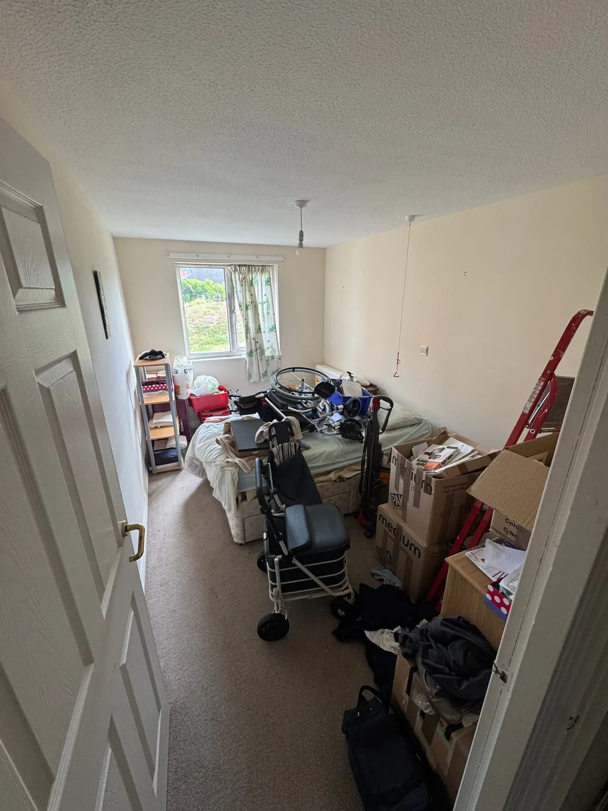 A cluttered bedroom before a clearance